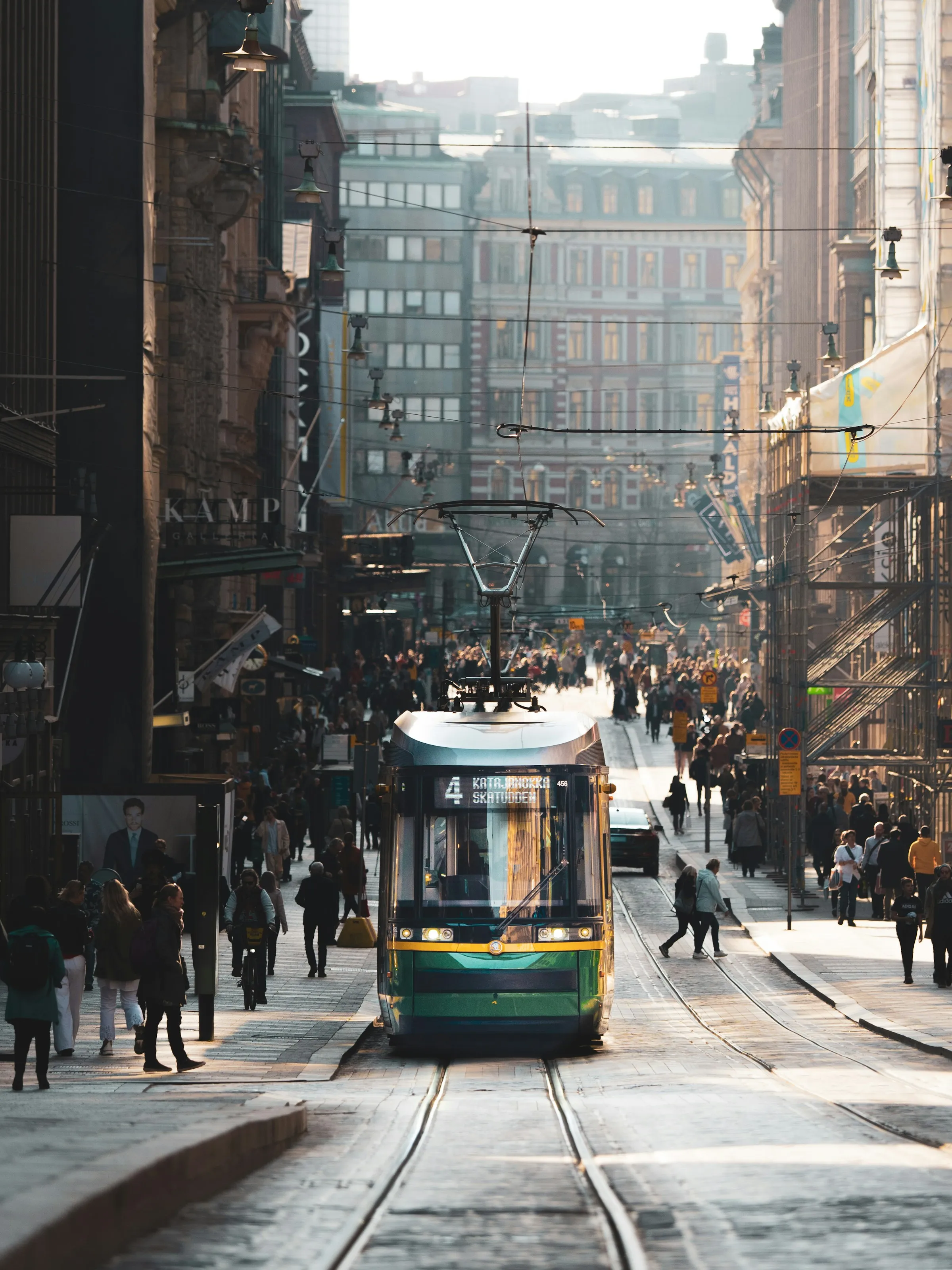 Tram 4 to Katajanokka on Aleksanterinkatu, Helsinki, surrounded by pedestrians in morning light